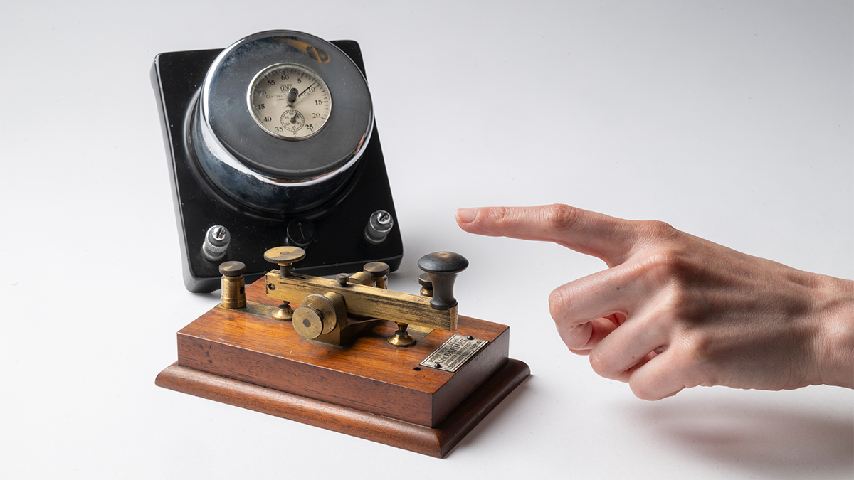 photo of hand with scientific instrument on white background