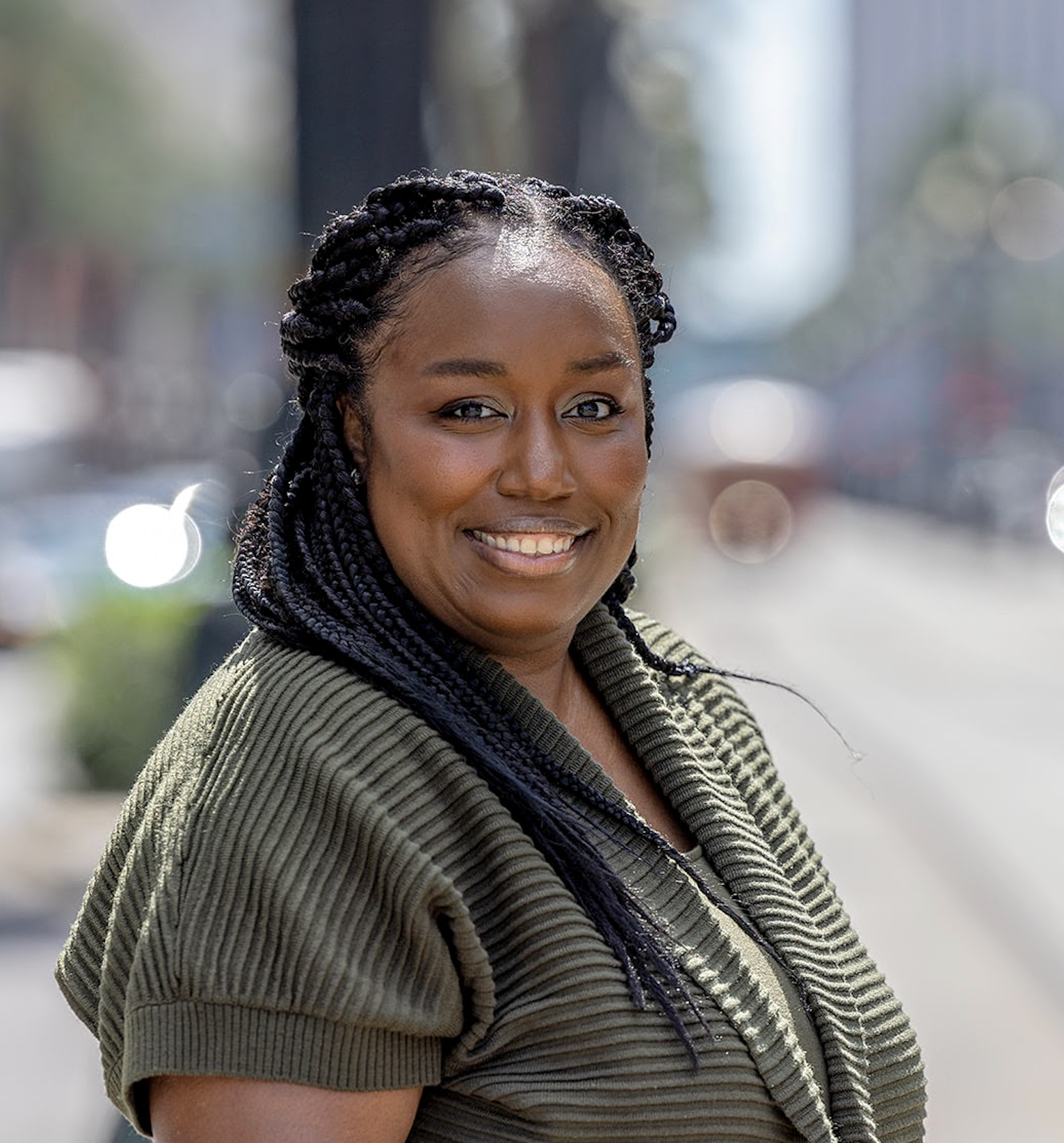 Dr. Cambria Nwosu from the waist up wearing a green shirt.