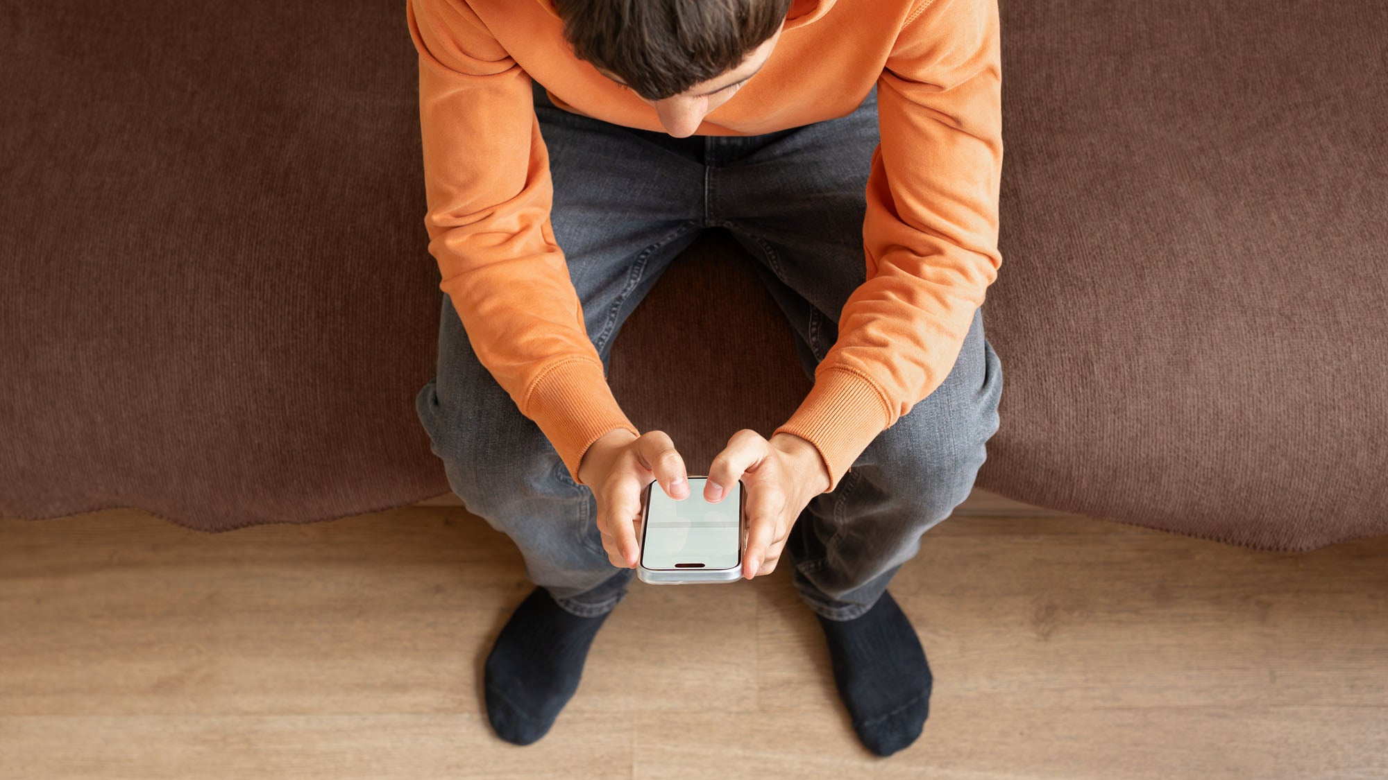 Teen boy looking at his phone