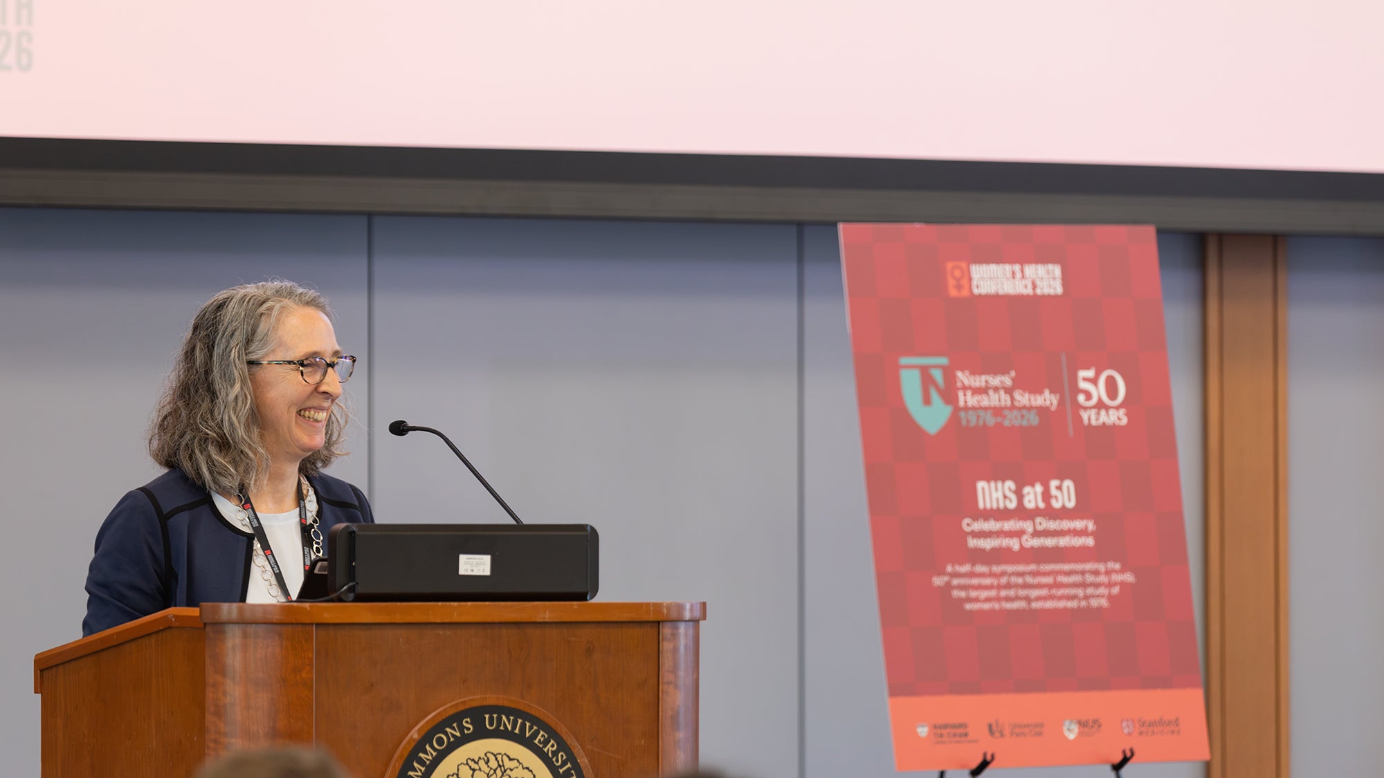Smiling woman behind a podium