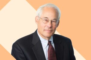 Donald Berwick headshot against a cream and tan background