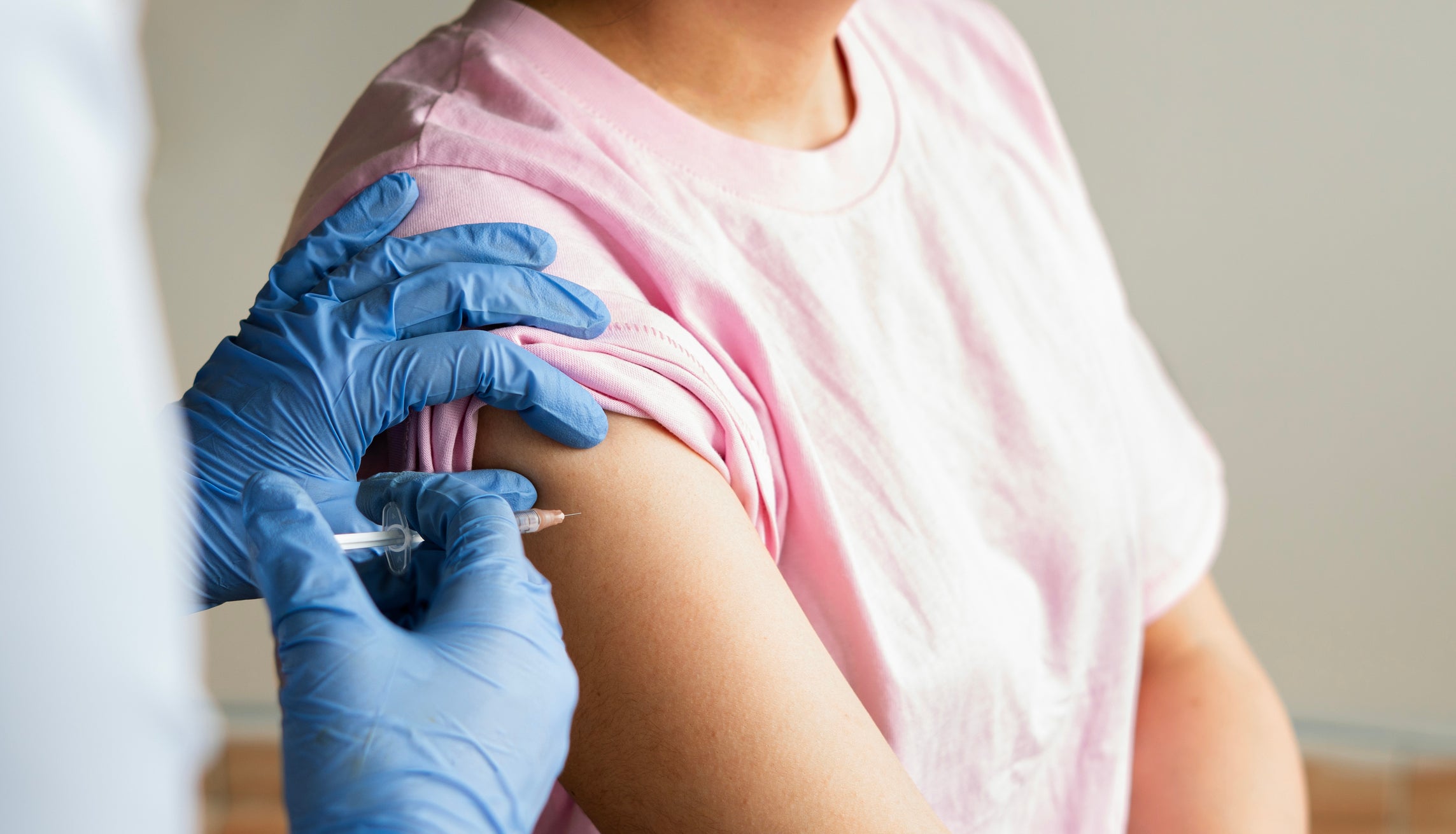 Close-up of a clinician giving a patient a vaccine